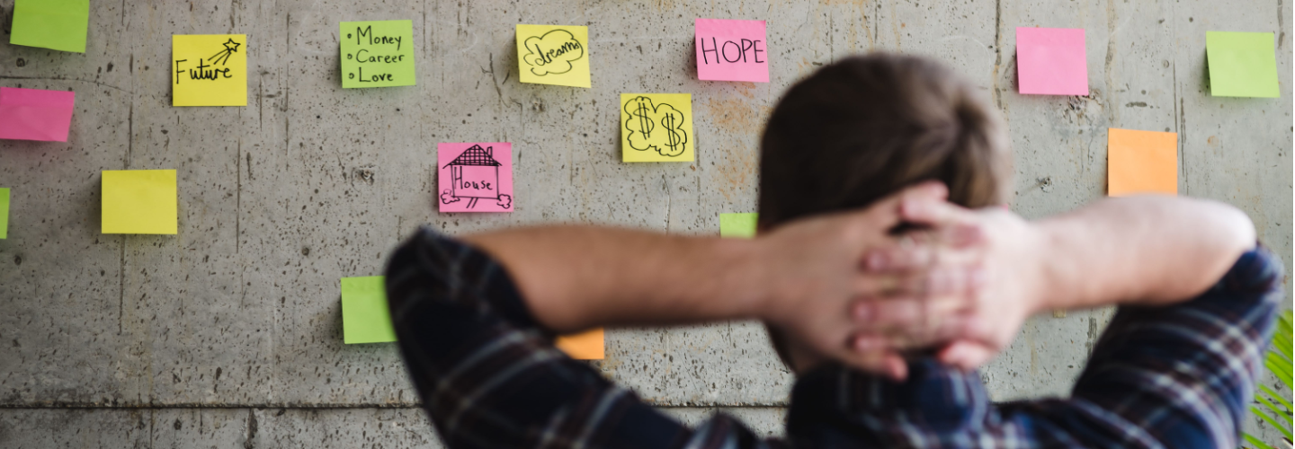 Man looking at wall with post-it notes