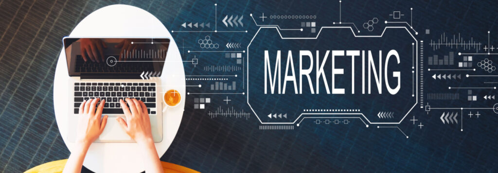 Marketing concept with person using a laptop on a white table